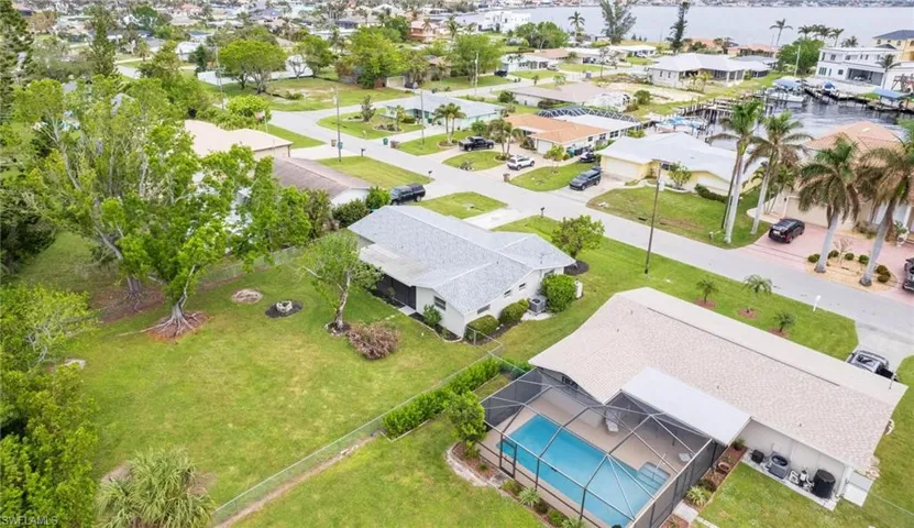 Birds eye view of property with a water view