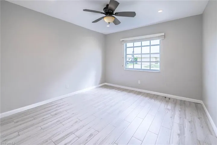 Spare room featuring ceiling fan and light hardwood / wood-style floors