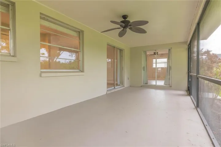 Unfurnished sunroom featuring ceiling fan