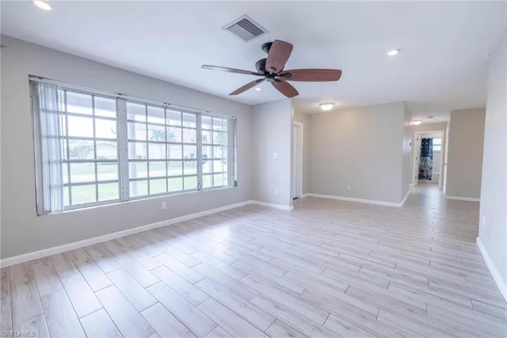 Unfurnished room featuring ceiling fan and light hardwood / wood-style flooring