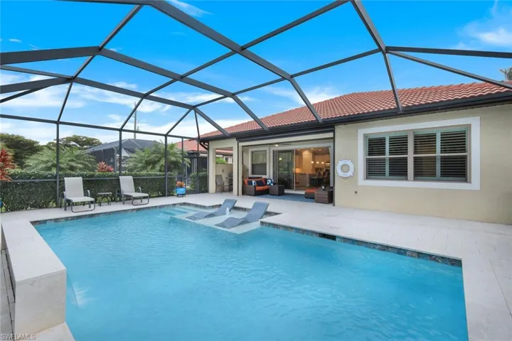 View of swimming pool with a lanai, a patio area, and a hot tub