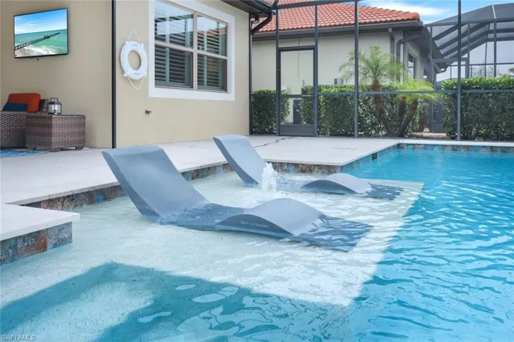 View of swimming pool featuring a lanai and a patio