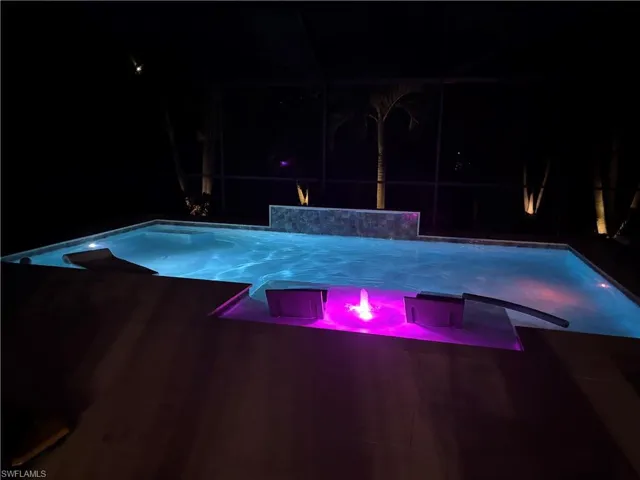 Pool at night with glass enclosure