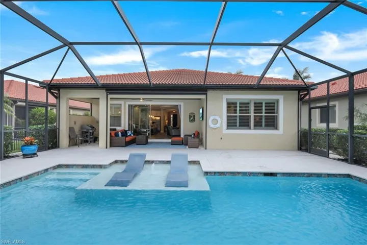 Back of house with ceiling fan, a lanai, an outdoor hangout area, and a patio area