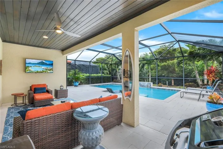 View of swimming pool with an outdoor hangout area, a lanai, a patio, and ceiling fan