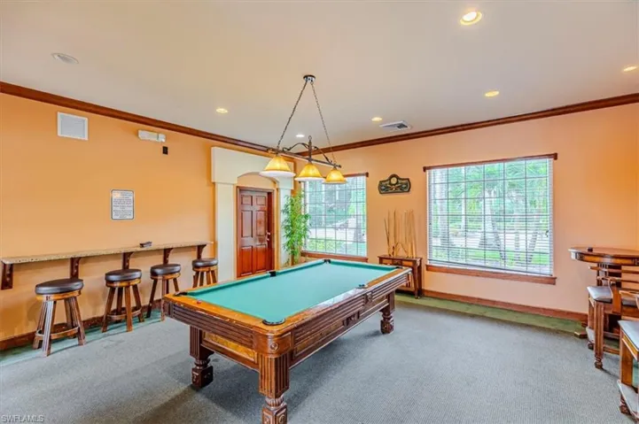 Rec room with ornamental molding, billiards, recessed lighting, light colored carpet, and a dry bar