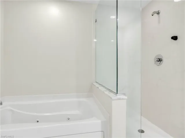 Full bath featuring a jetted tub and a walk in shower