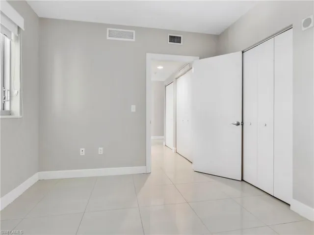 Unfurnished bedroom with light tile patterned floors and a closet