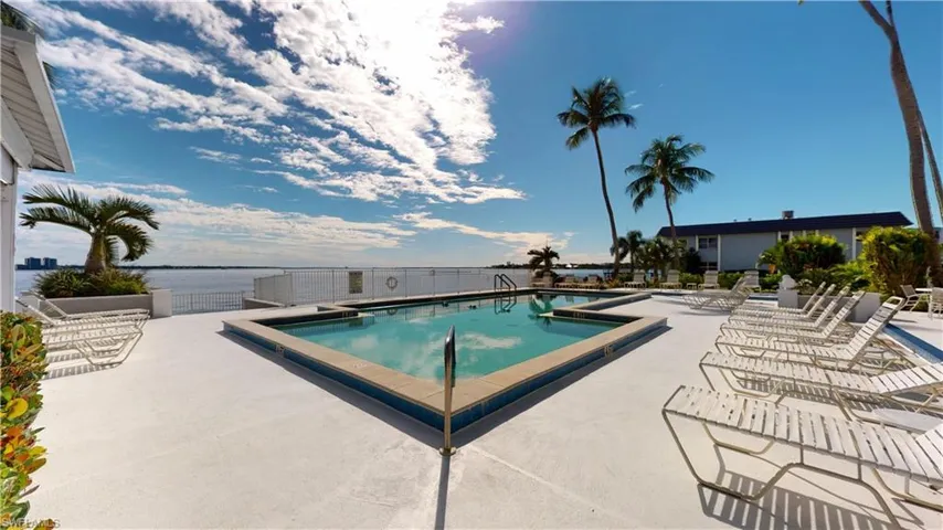 Community pool with a patio area and a water view