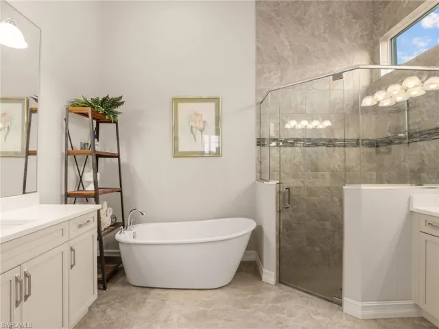 Ceiling to floor shower tile, two sinks and soaking tub