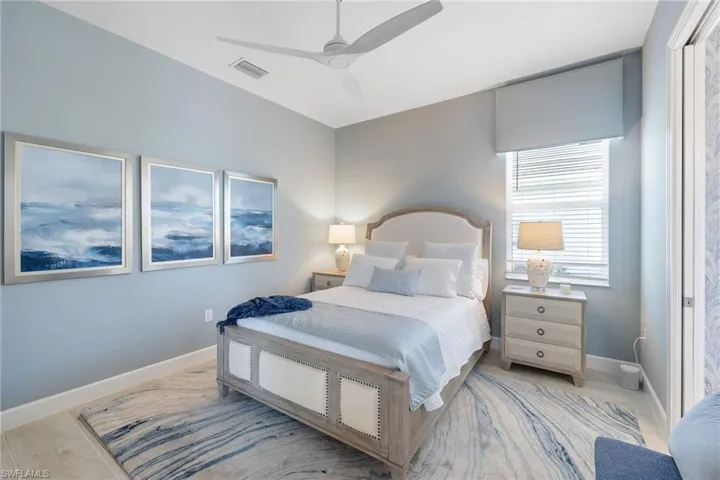 Bedroom featuring ceiling fan and light tile floors