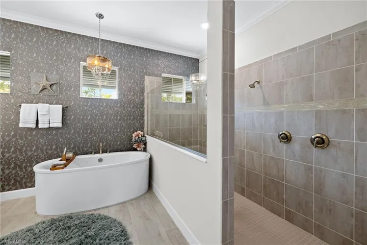 Bathroom with independent shower and bath and ornamental molding