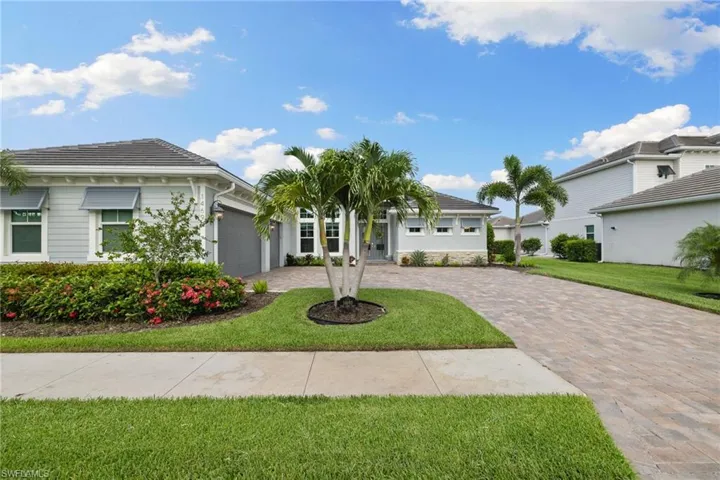 View of front of property with a garage and a front yard