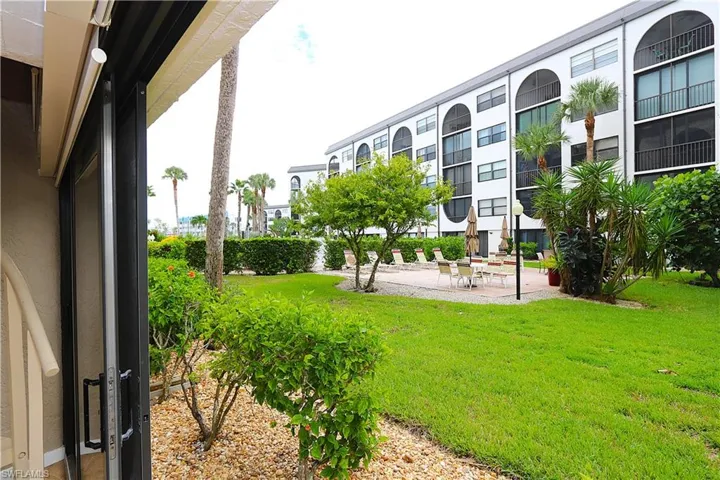 View of community with a patio area and a yard