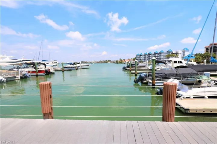 Dock area featuring a water view and view of marina