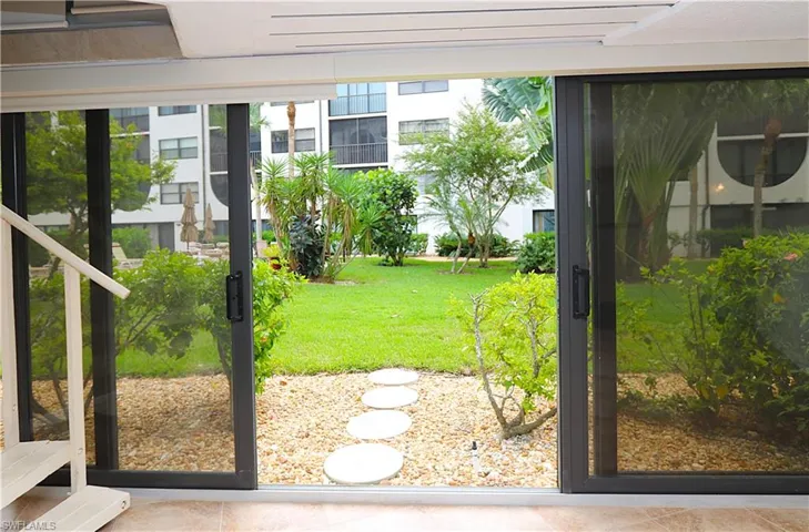 Doorway to outside featuring healthy amount of natural light and tile patterned flooring