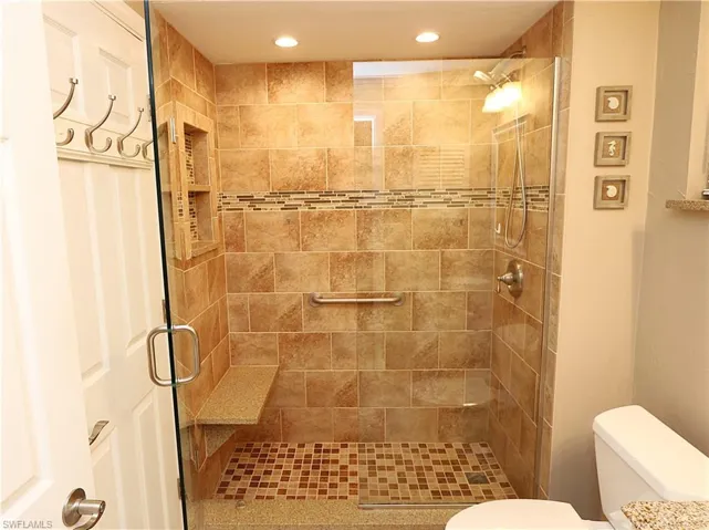 Bathroom featuring a stall shower and recessed lighting