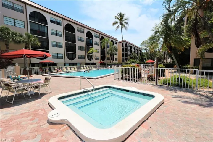 Community pool with a hot tub and a patio area