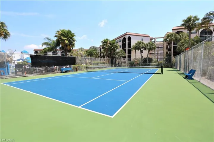 View of tennis court with community basketball court