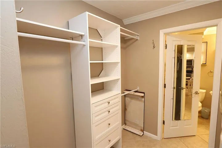Walk in closet featuring light tile patterned floors