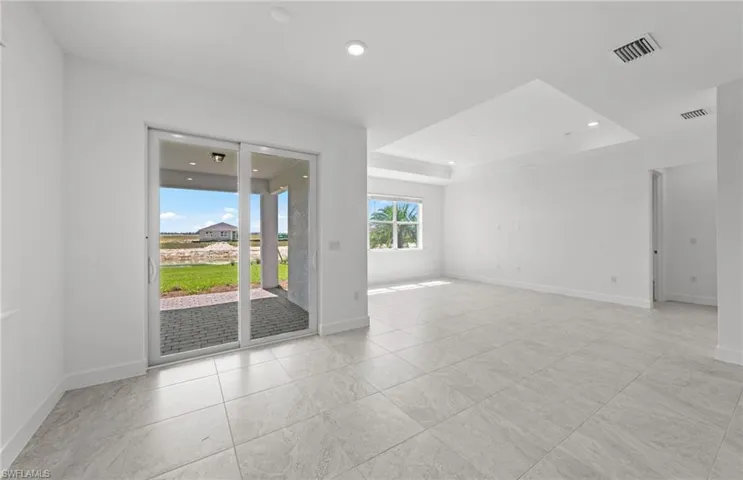 Tiled empty room with a raised ceiling
