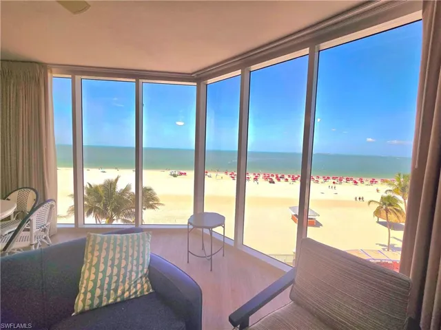 Liv room with a beach view, a water view, and a healthy amount of sunlight