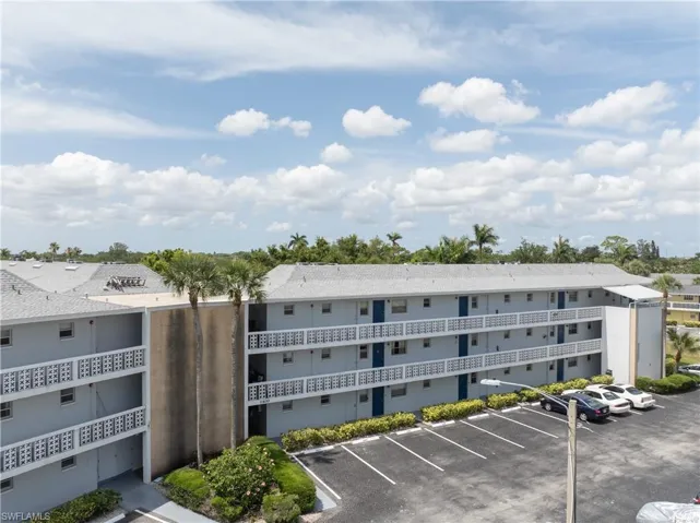 View of property featuring uncovered parking