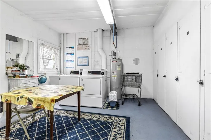 Basement with separate washer and dryer and electric water heater