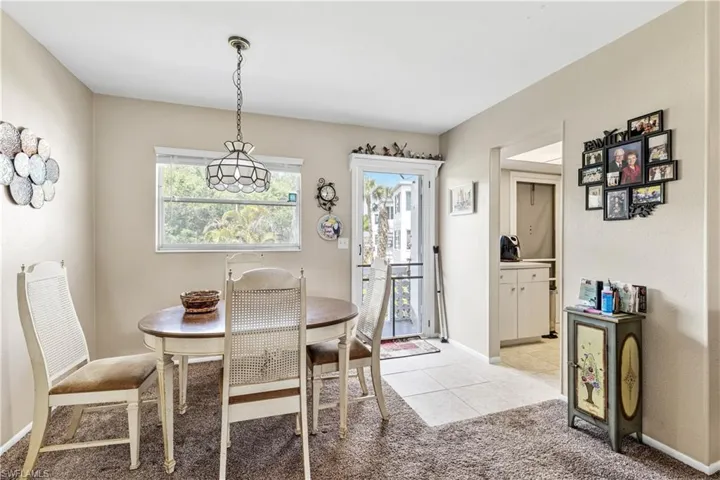 Dining area featuring baseboards, light tile patterned floors, and light colored carpet