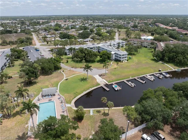 Aerial overview of property's location with a nearby body of water and a pool