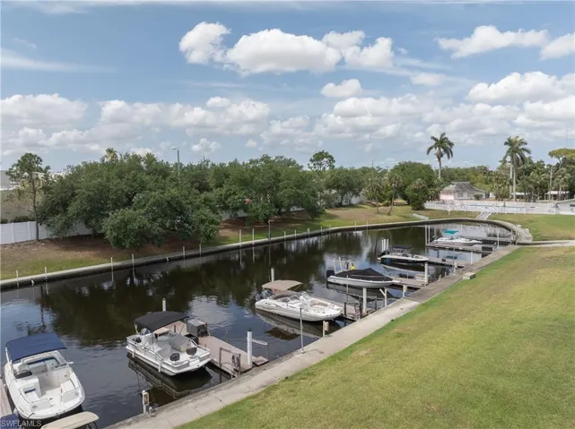 Dock featuring a water view and a yard