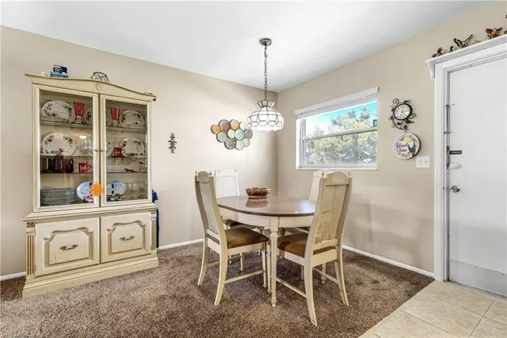 Dining space featuring baseboards and light tile patterned floors