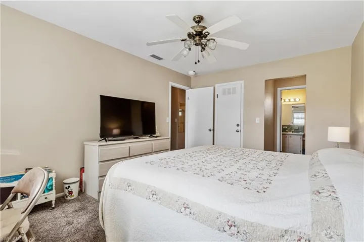 Carpeted bedroom featuring baseboards and ceiling fan