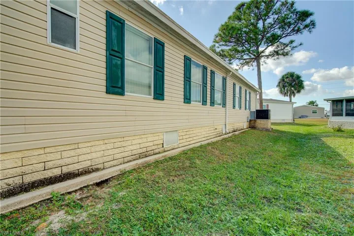 View of home's exterior featuring a lawn and crawl space
