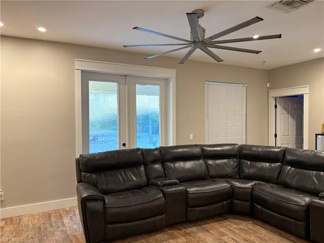 Living area featuring recessed lighting, hardwood / wood-style floors, a ceiling fan, and french doors