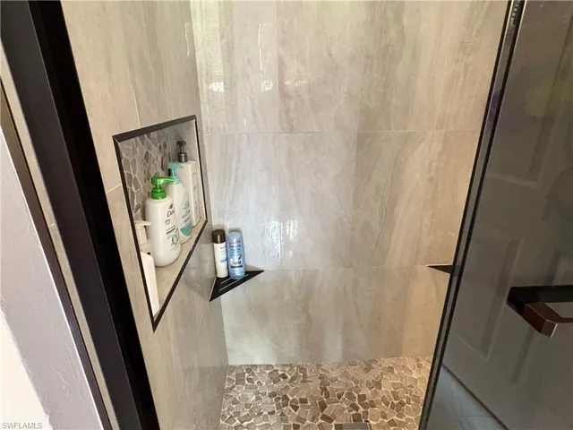Bathroom view of a tile shower