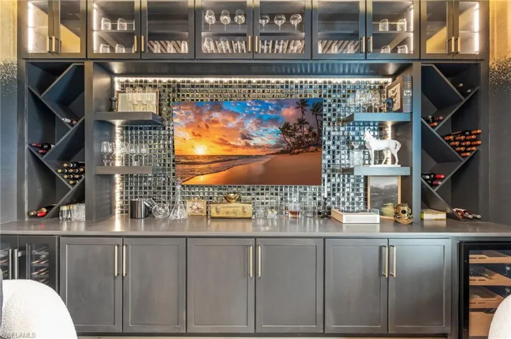 Wine area featuring wine cooler and a community bar