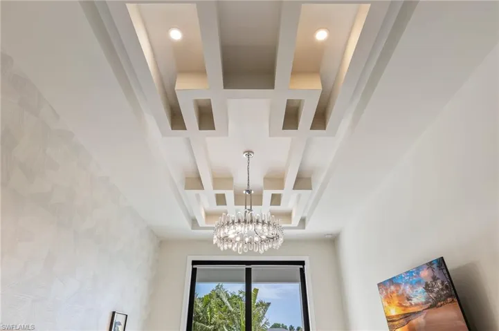 Detailed view of a chandelier and recessed lighting