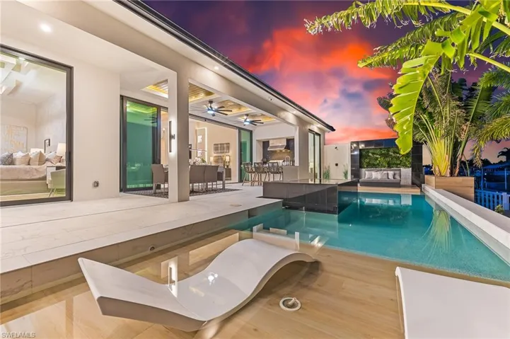 Outdoor pool featuring a ceiling fan, a patio, and an outdoor hangout area