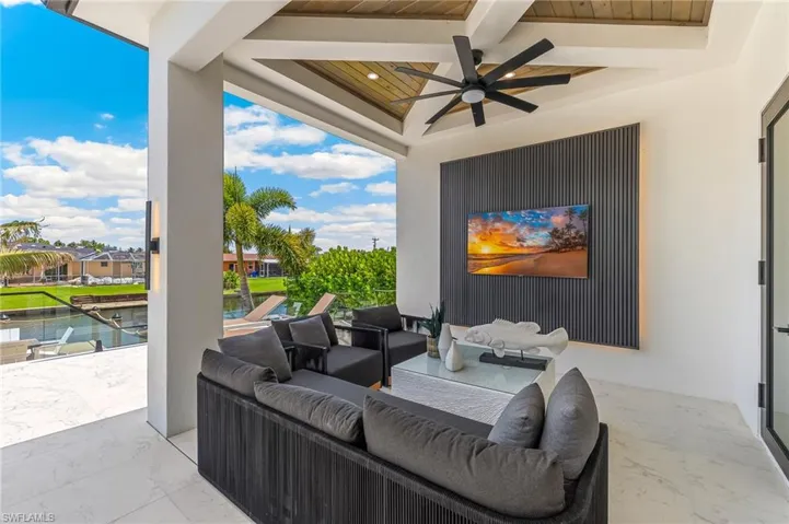 View of patio / terrace featuring ceiling fan, an outdoor living space, and a water view
