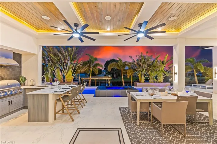 View of patio / terrace featuring area for grilling, ceiling fan, and an outdoor pool