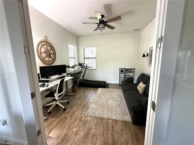 Den with wood-look tile flooring