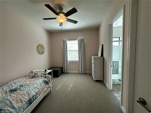 Carpeted bedroom with ceiling fan