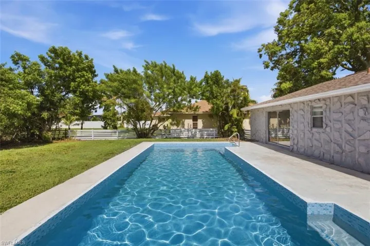 Rectangular swimming pool with integrated steps and a surrounding concrete deck