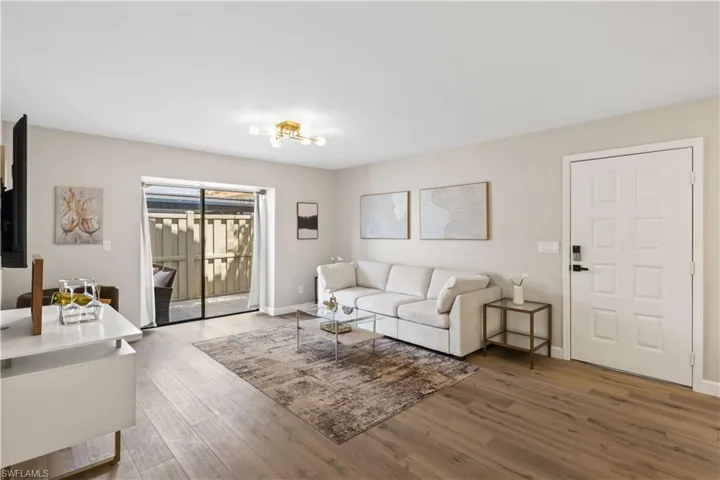 The room is bathed in natural light from large sliding glass doors that lead out to your private lanai.