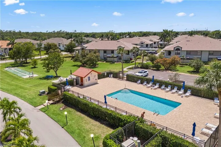 The sparkling blue water of the pool is the focal point, with plenty of space for lounging around on comfortable poolside chairs.