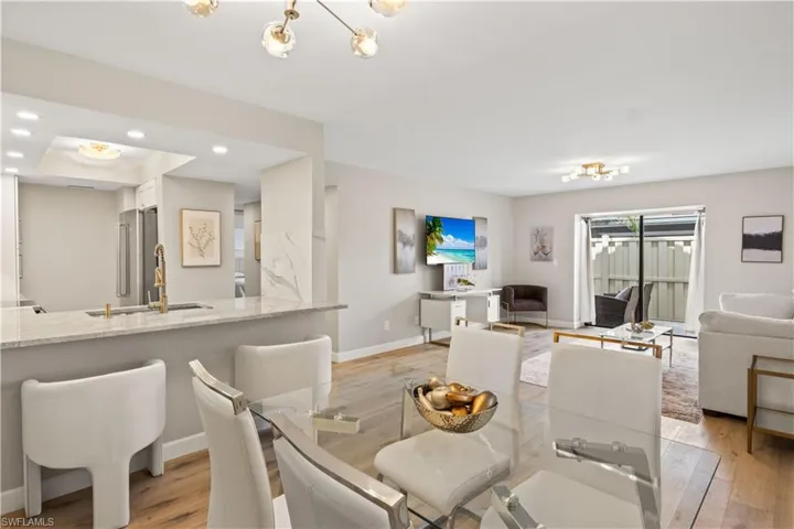 Natural light from large sliding glass doors that lead out to a private lanai, offering a relaxing outdoor spot.