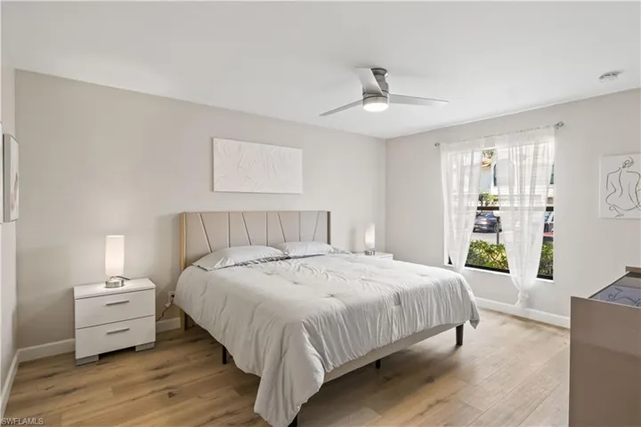 A tranquil primary bedroom with a brand-new queen-sized bed and contemporary furnishings.