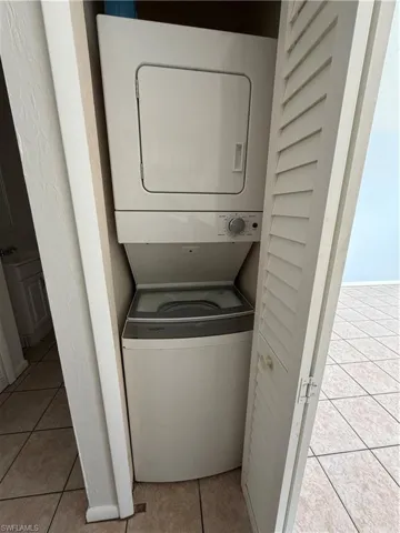 Laundry area with  stacked washer and dryer