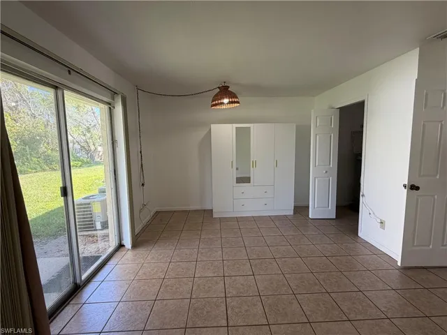 Unfurnished bedroom with access to backyard